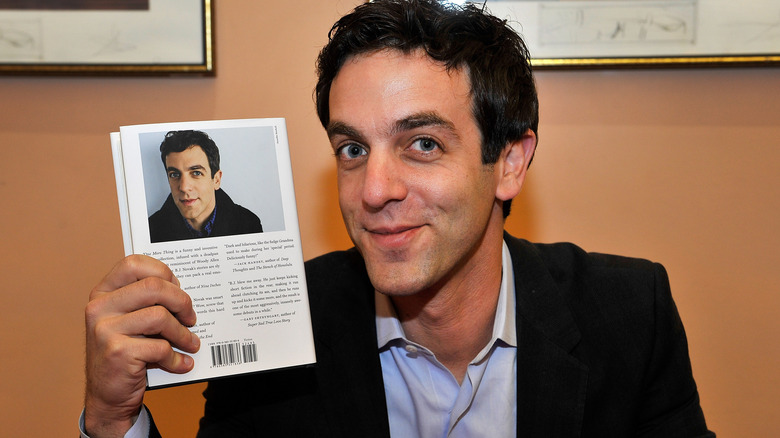 B.J. Novak holding his book