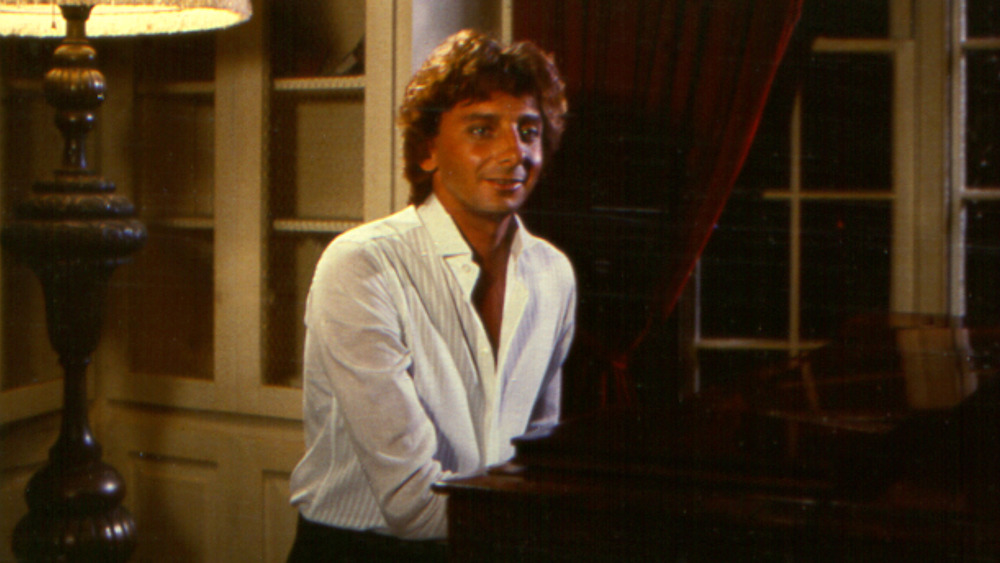 A young Barry Manilow playing the piano