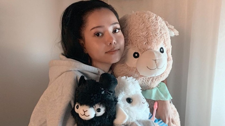 Bella Poarch hugs stuffed alpacas