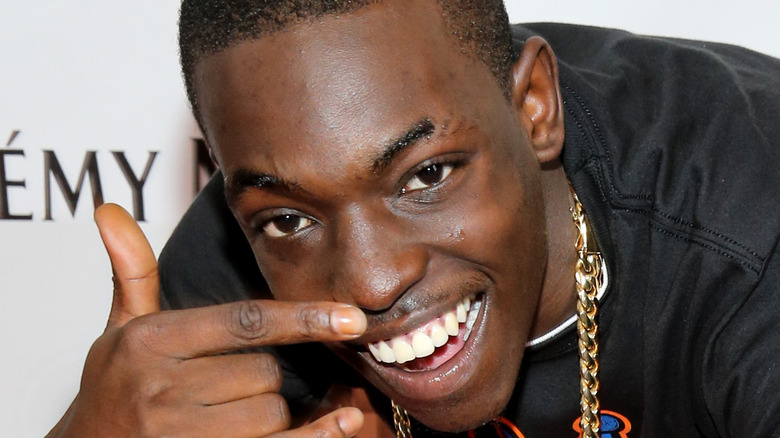 Bobby Shmurda crouching down