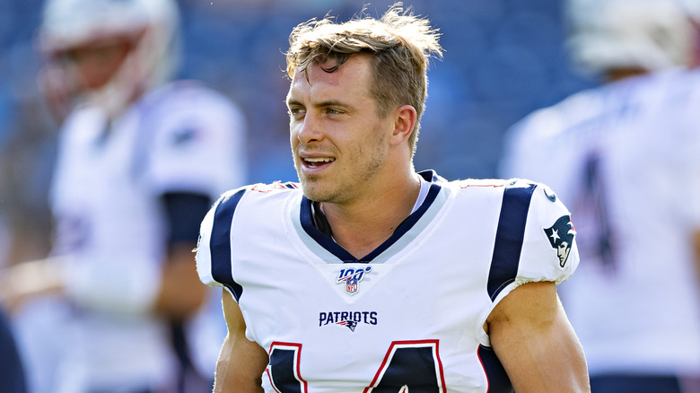 Braxton Berrios walking in a New England Patriots jersey