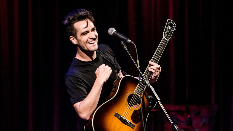 Brendon Urie holding a guitar