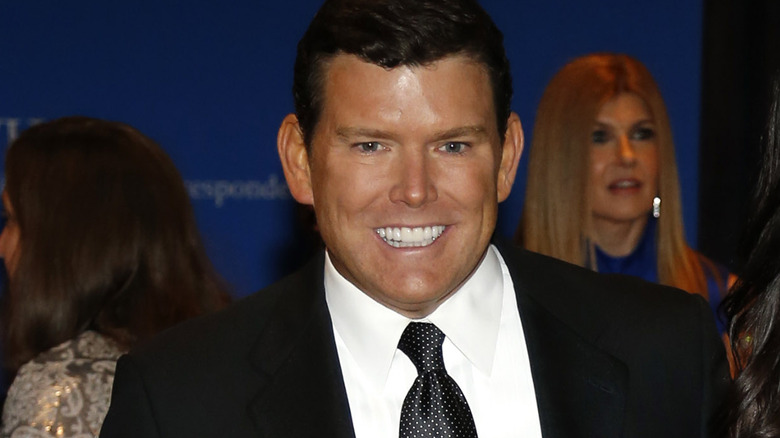 Bret Baier posing for cameras, flashing teeth