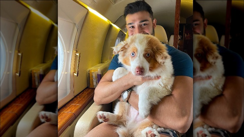 Sam Asghari holding a dog