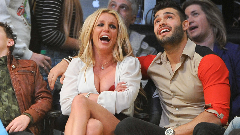 Britney Spears and Sam Asghari laughing at a basketball game