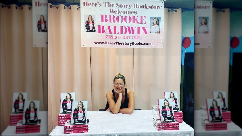 Brooke Baldwin seated at book signing