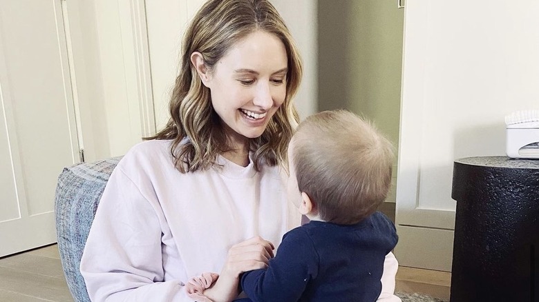 Caitlin Thompson playing with her son