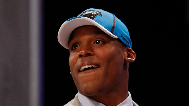 Cam Newton in blue hat 