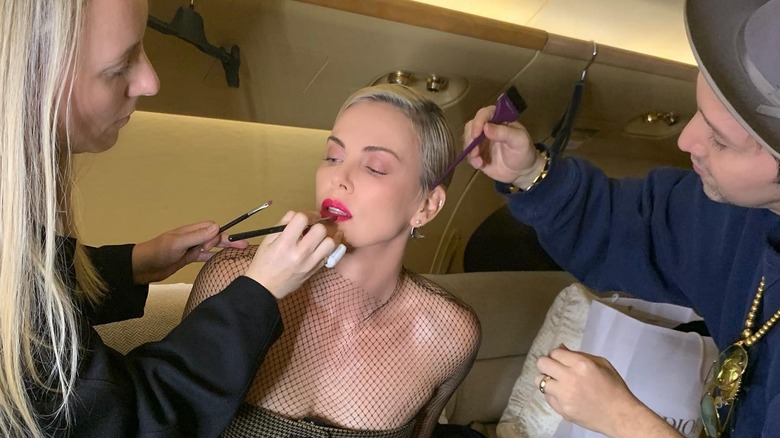 Charlize Theron getting makeup put on