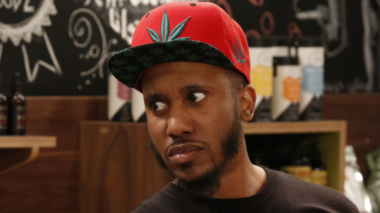 Chris Redd on Disjointed in a red hat