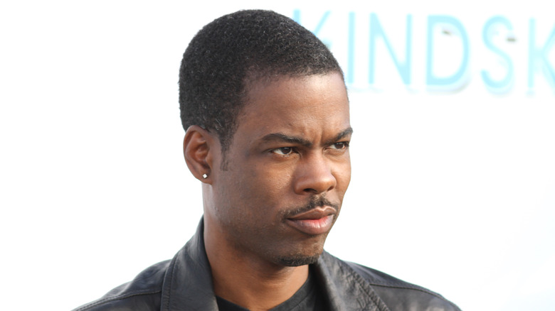 Chris Rock frowning at cameras