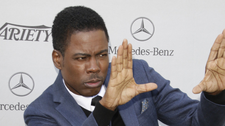 Chris Rock with his hands up