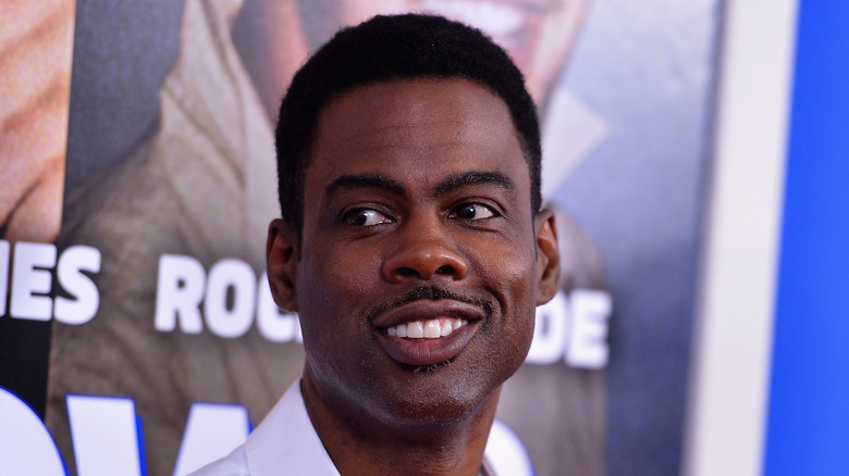 Chris Rock with a sly smile