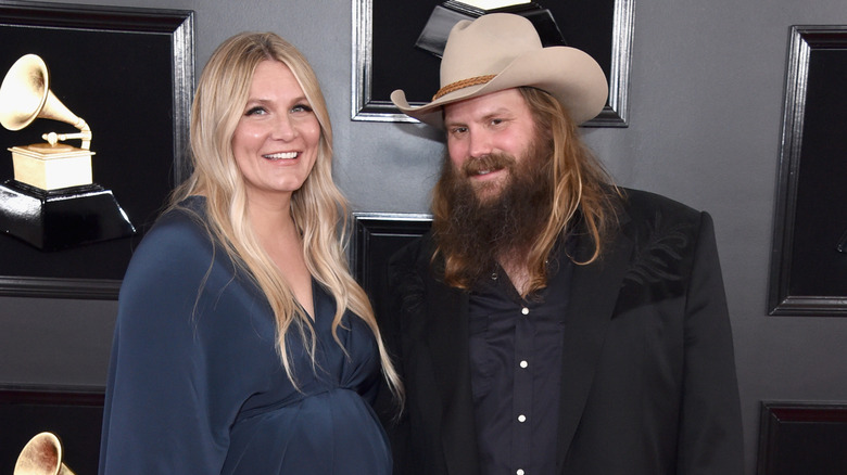 Chris Stapleton posing with his pregnant wife