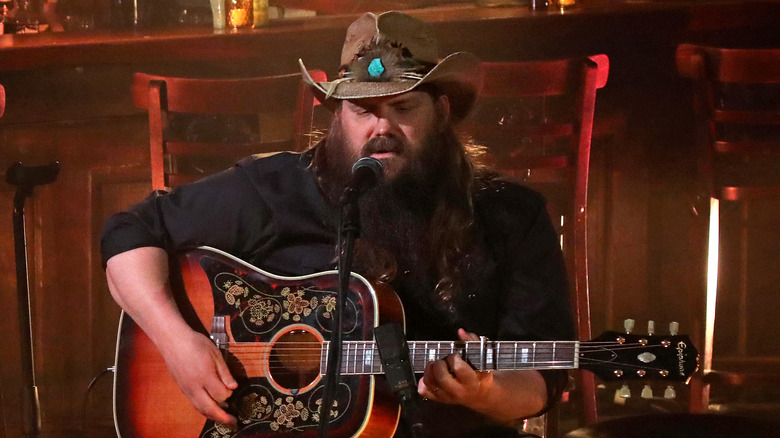 Chris Stapleton playing guitar and singing