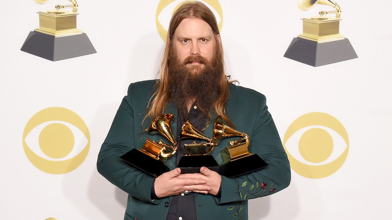 Chris Stapleton posing with his Grammy awards 