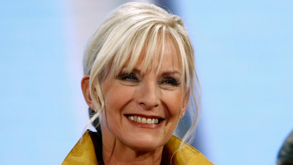 Cindy McCain in a yellow jacket, smiling with her hair pulled back