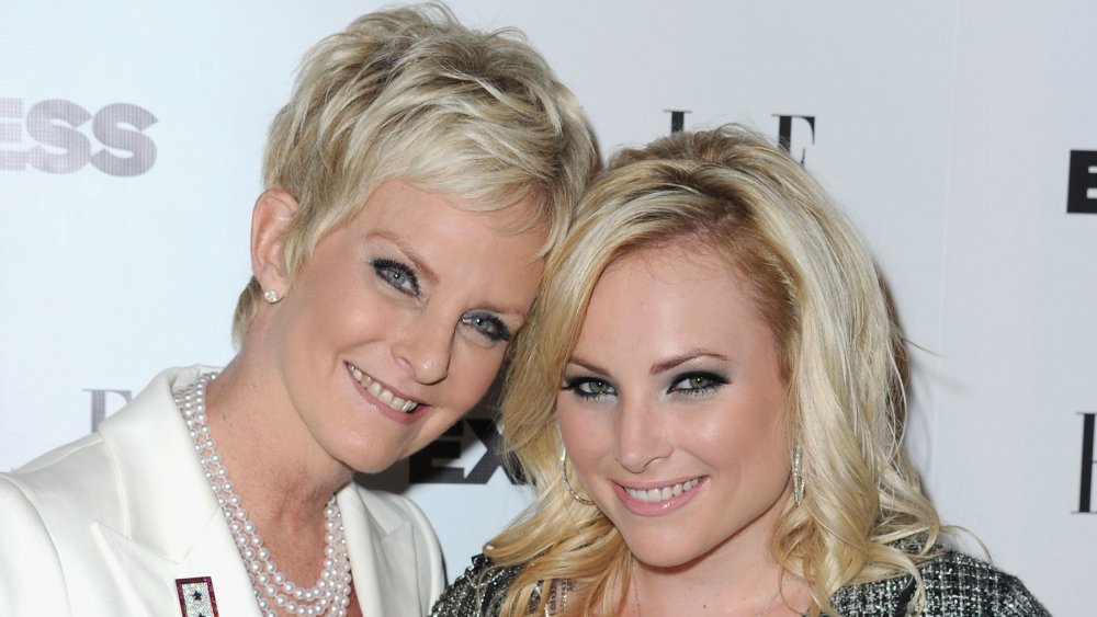 Cindy McCain and Meghan McCain smiling and posing with their heads against one another