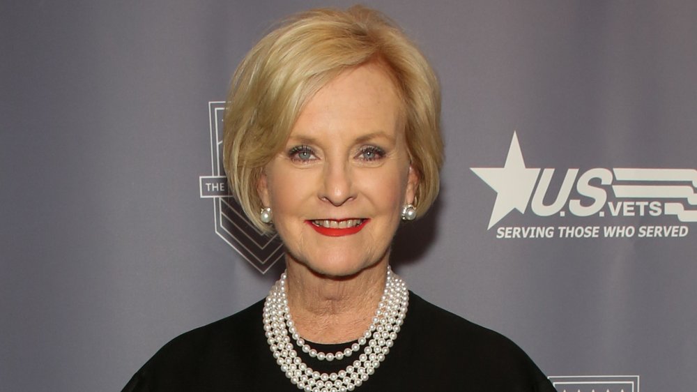 Cindy McCain in a black dress and pearl necklace, smiling at a veterans event