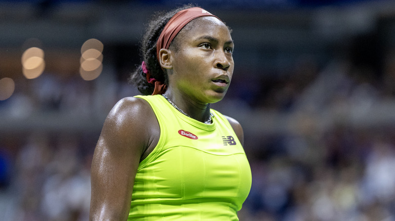 Coco Gauff playing on court a lime green tennis outfit