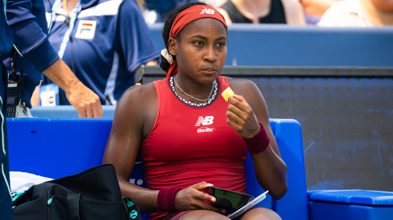 Coco Gauff eating pineapple on the sidelines