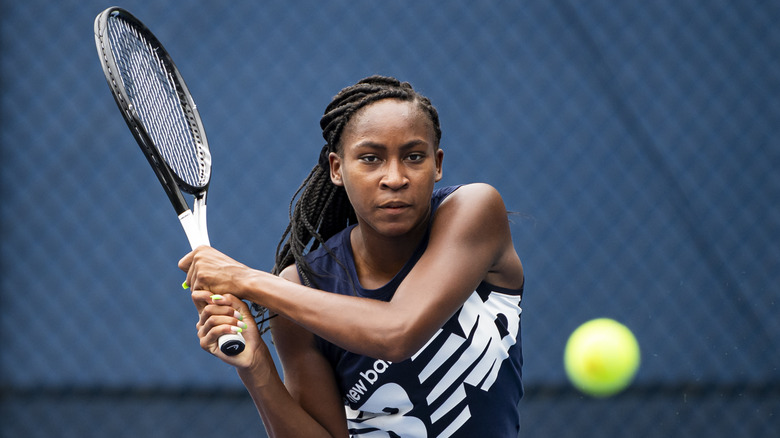 Coco Gauff's swinging her tennis racket