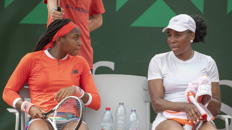 Coco Gauff and Venus Williams talking on the sidelines