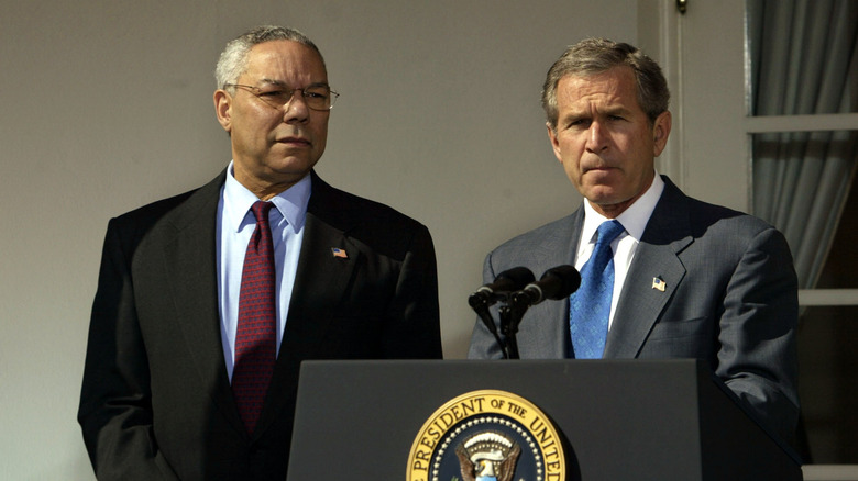 Colin Powell and George W. Bush standing together