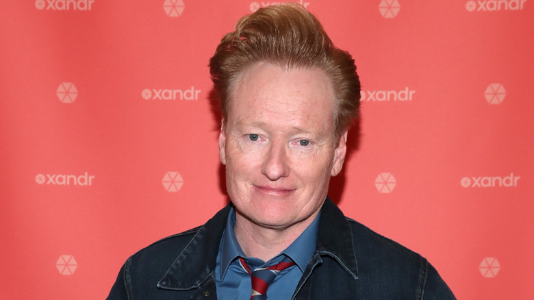 Conan O'Brien in a striped tie, smiling