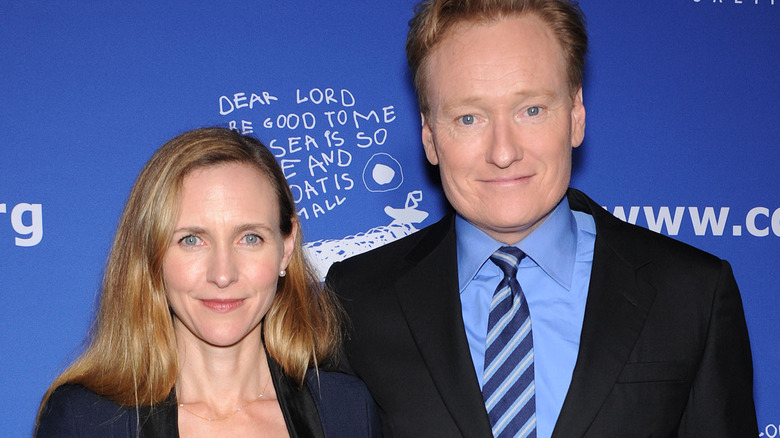 Conan O'Brien with his arm around his wife Liza