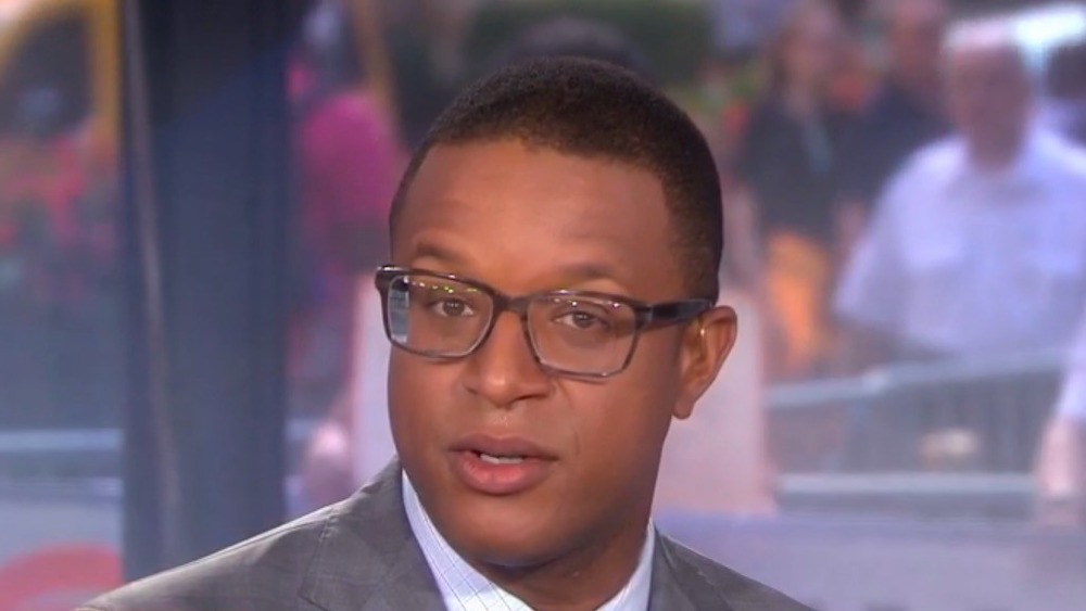 Craig Melvin with glasses on looking at camera