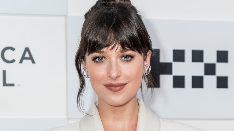 Dakota Johnson poses dark hair