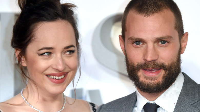 Dakota Johnson smiling at Jamie Dornan