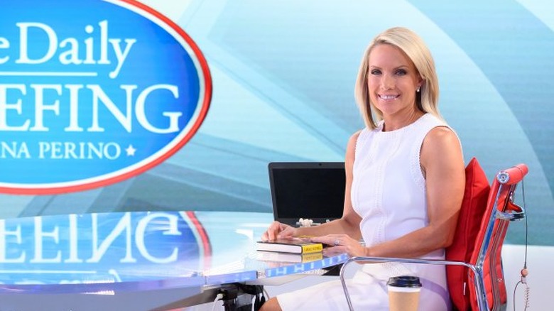 Dana Perino smiling with a book