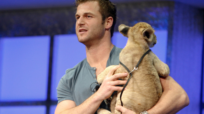 Dave Salmoni on stage with lion cub