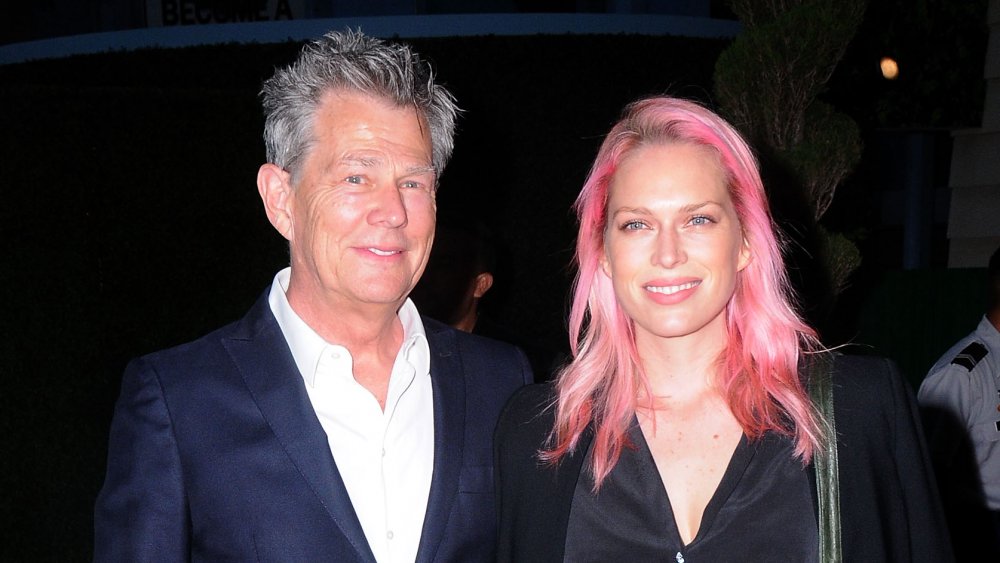 David Foster in blue blazer and white shirt, Erin Foster with pink hair and black outfit, posing together at an event