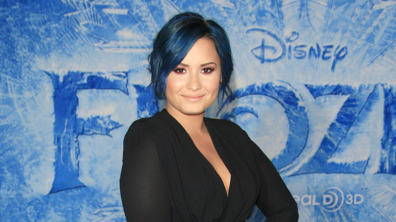 Demi Lovato with blue hair on the red carpet