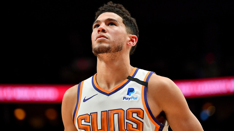 Devin Booker, posing on the court