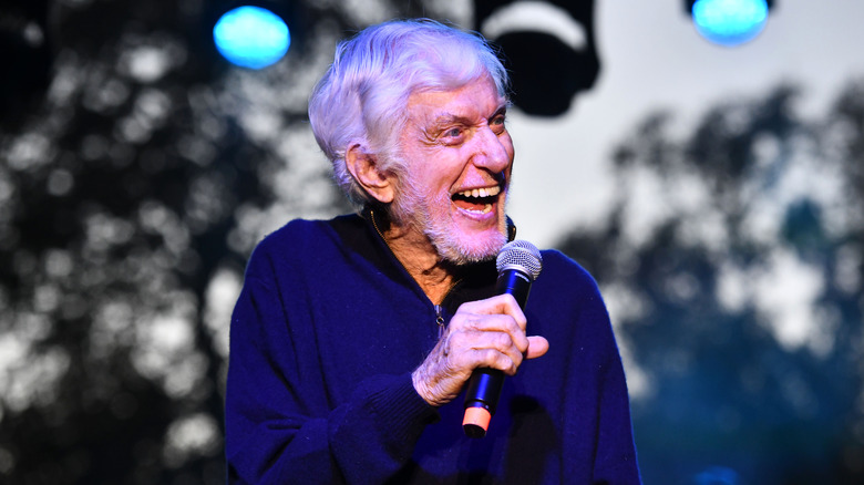 Dick Van Dyke holding a mic