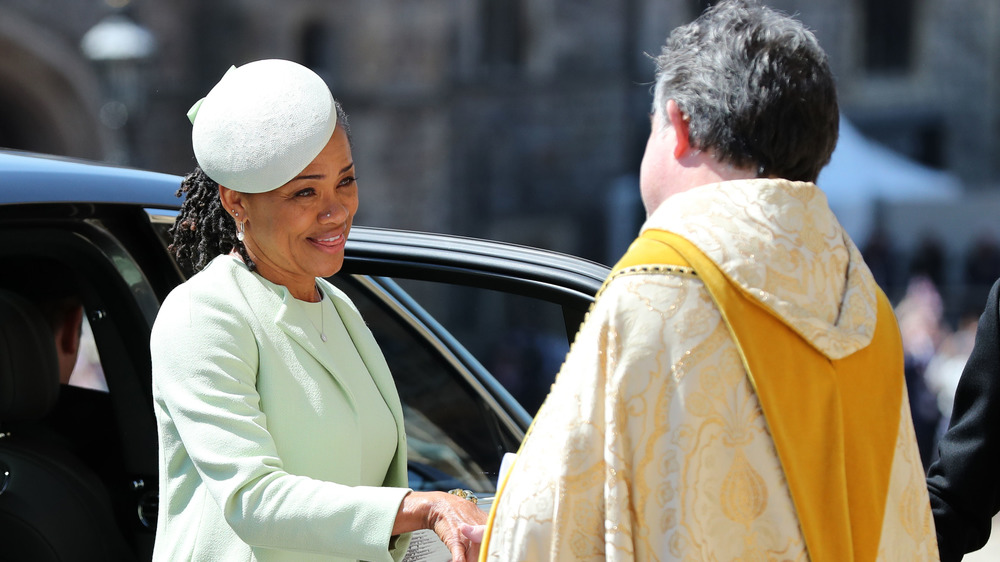 Doria Ragland shaking hand of priest