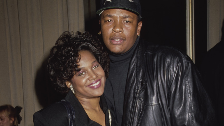 Michel'le and Dr. Dre smiling and posing together