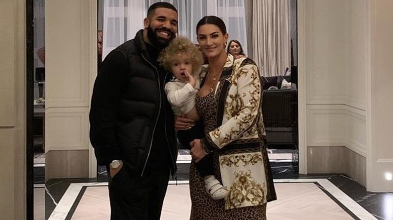 Drake posing with Adonis and Sophie Brussaux