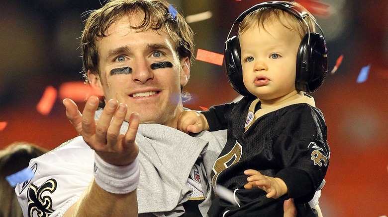 Drew Brees, posing with his son Baylen Brees