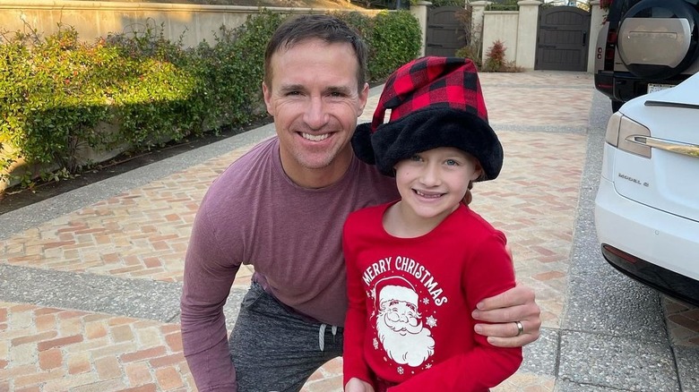 Drew Brees posing with Rylen Brees, both smiling