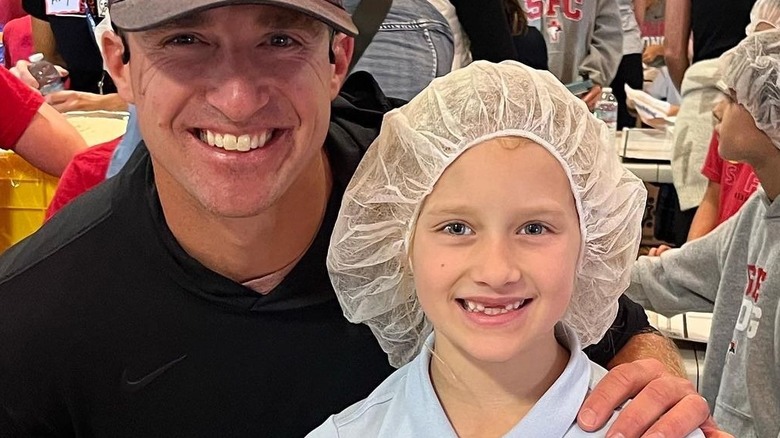 Drew Brees and his daughter Rylen, both smiling