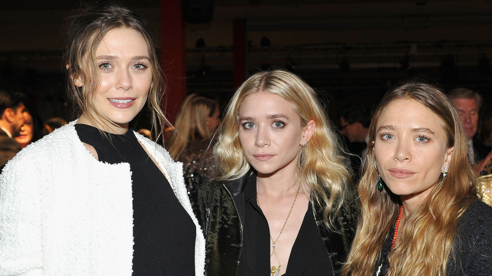 Elizabeth Olsen, Ashley Olsen, and Mary-Kate Olsen posing together