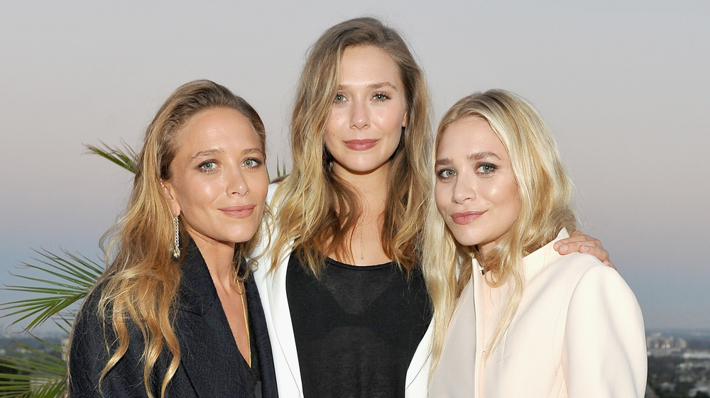 Mary-Kate Olsen, Elizabeth Olsen, and Ashley Olsen posing together