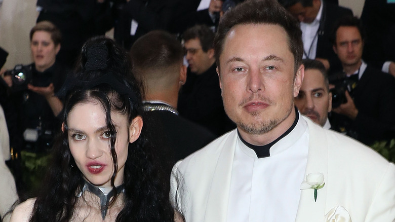 Grimes and Elon Musk posing