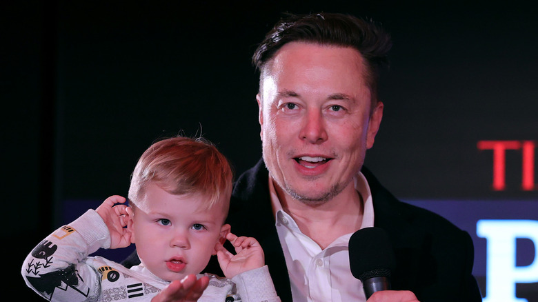 Elon Musk holding his son