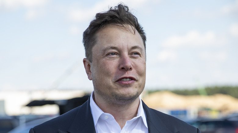 Elon Musk speaking outdoors